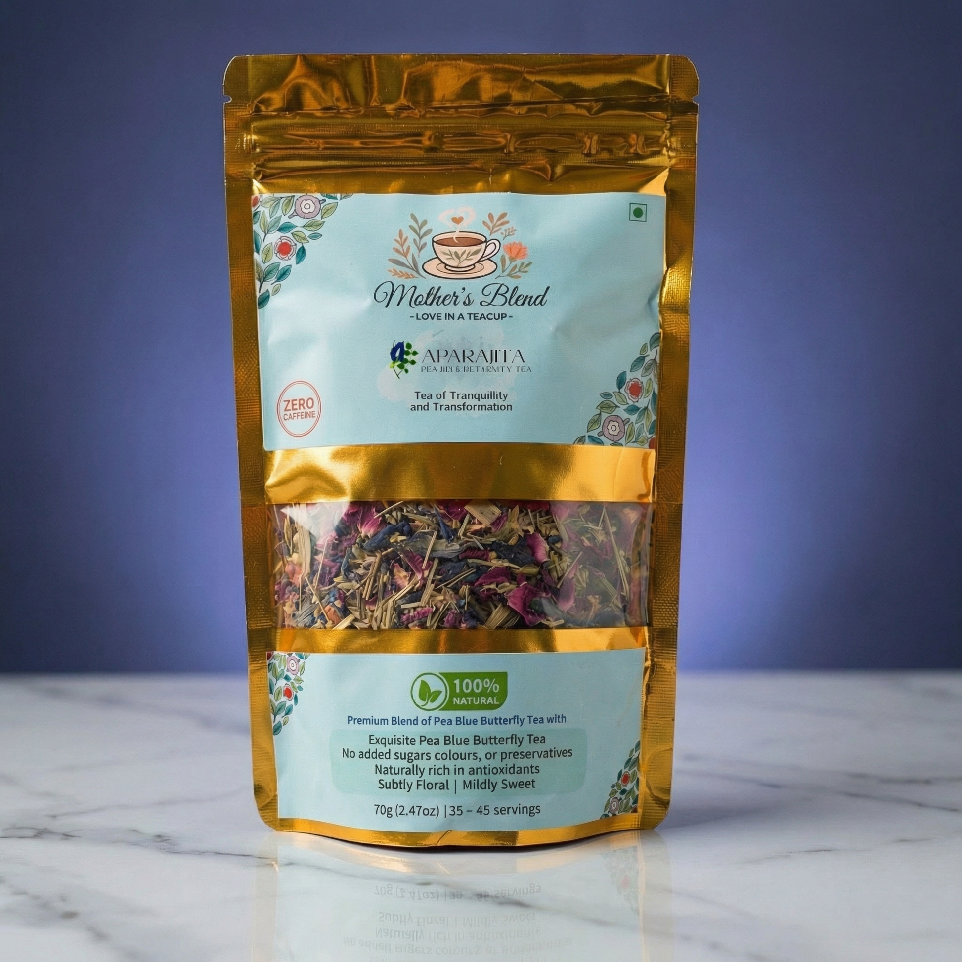 Butterfly pea blue tea package labeled 'Mother's Blend' on a marble surface with a purple background